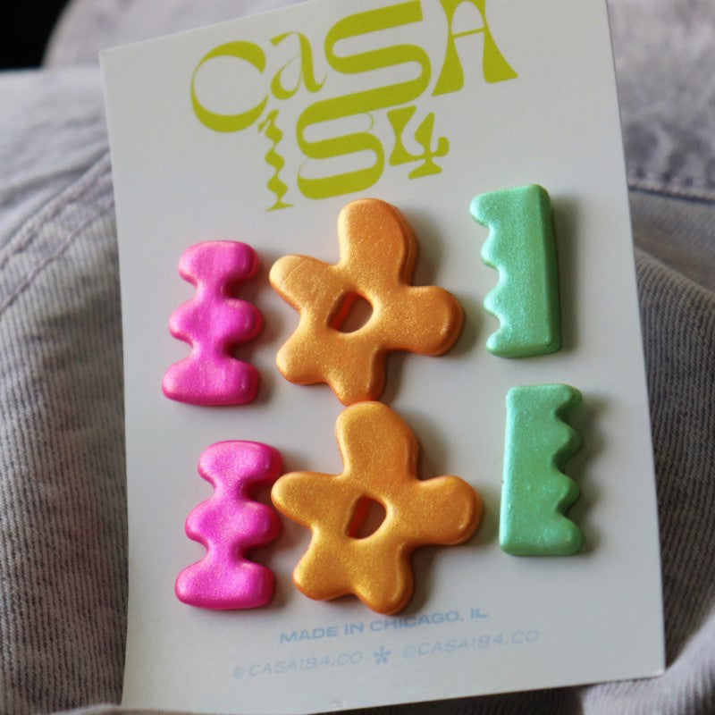 card of 3 pairs of iridescent, brightly colored polymer clay earrings in fun shapes