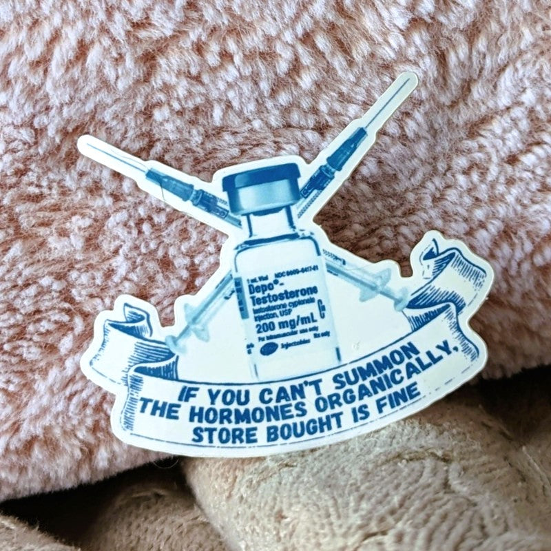 sticker featuring a vial of testosterone, syringes, and the words "if you can't summon the hormones organically, store bought is fine"