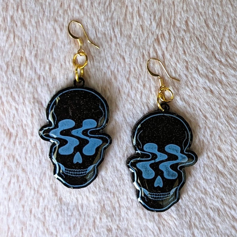 cool resin earrings of warped skulls