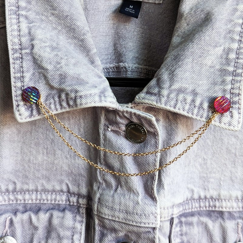 dark pink iridescent lapel pins, with gold chains between them