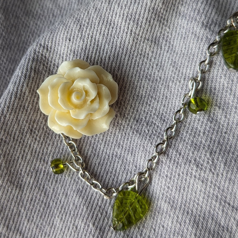 cute pink rose lapel pin, with a gold chain and leaf beads