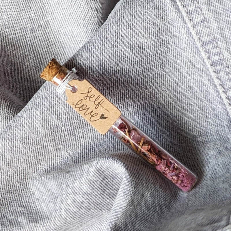 cute tiny vial filled with materials for a self love spell