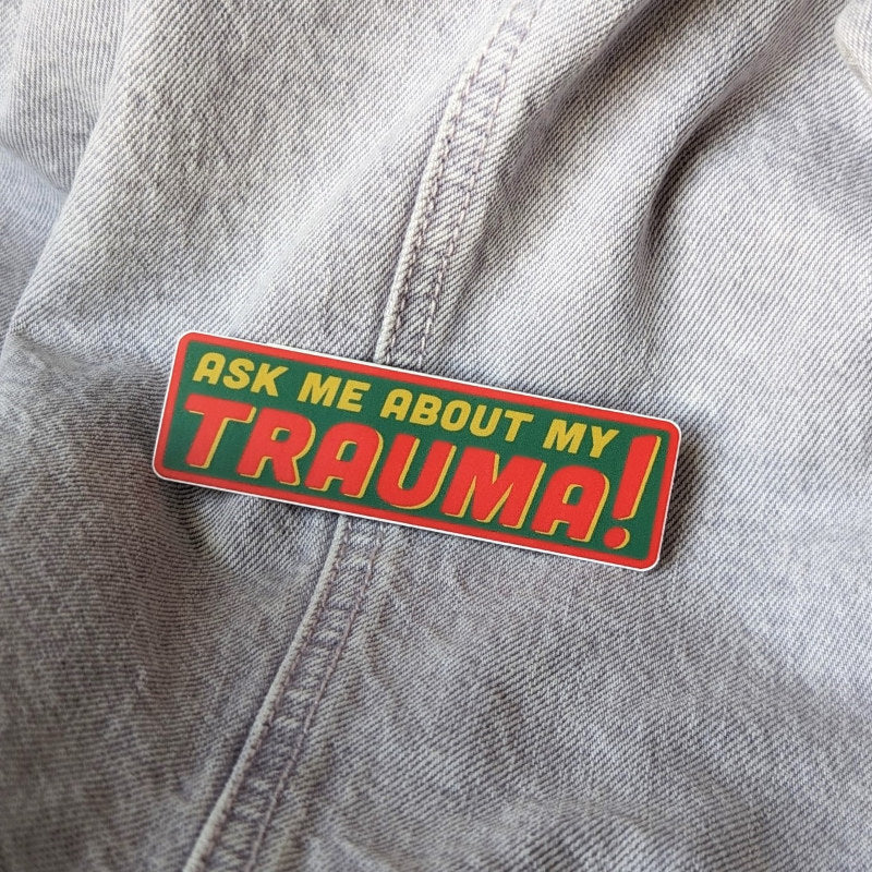 funny vinyl sticker that says "ask me about my trauma!"