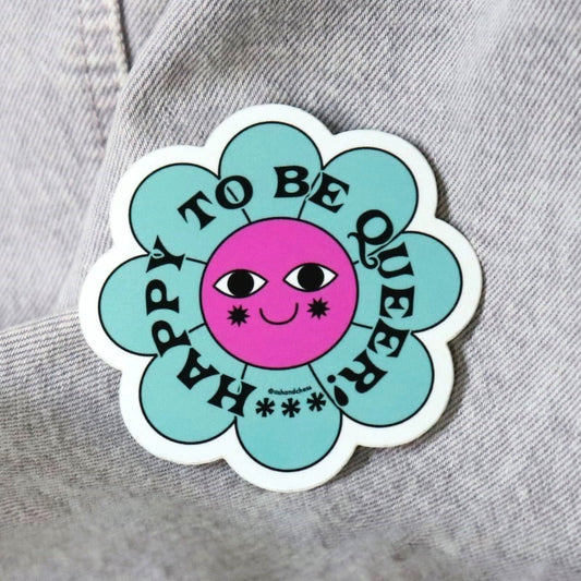 sticker of a flower that says "happy to be queer"