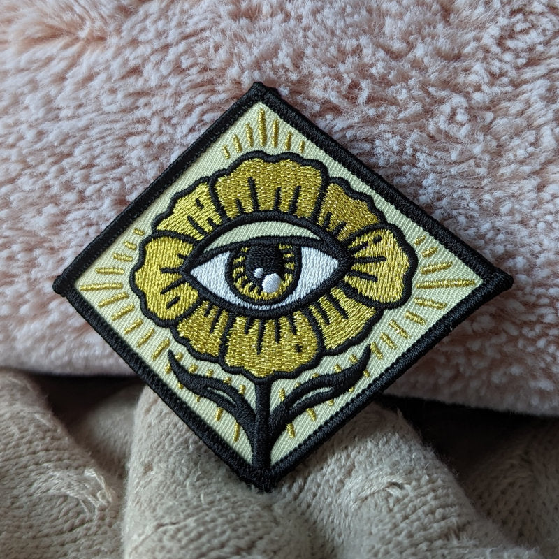 mystical embroidered patch featuring an eye in a flower