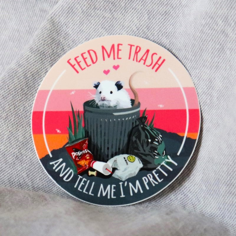 cute sticker of an opossum in a trash can and the words "feed me trash and tell me i'm pretty"