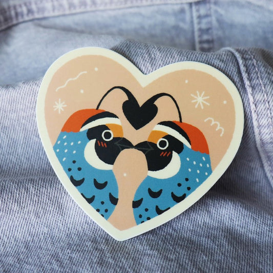 cute heart shaped sticker with two male quails facing each other