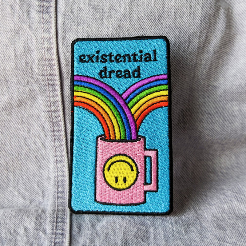 funny embroidered patch that says "existential dread" and pictures a coffee cup with rainbows going into it