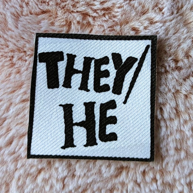 punk style iron-on canvas patch with the words "they/he"