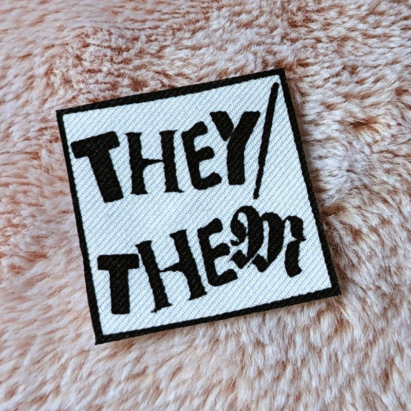 punk style iron-on canvas patch with the words "they/them"