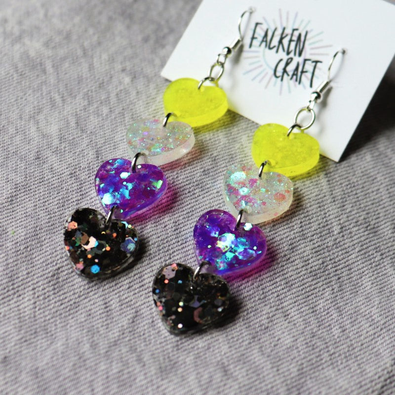 dangly earrings with hearts in the colors of the nonbinary flag