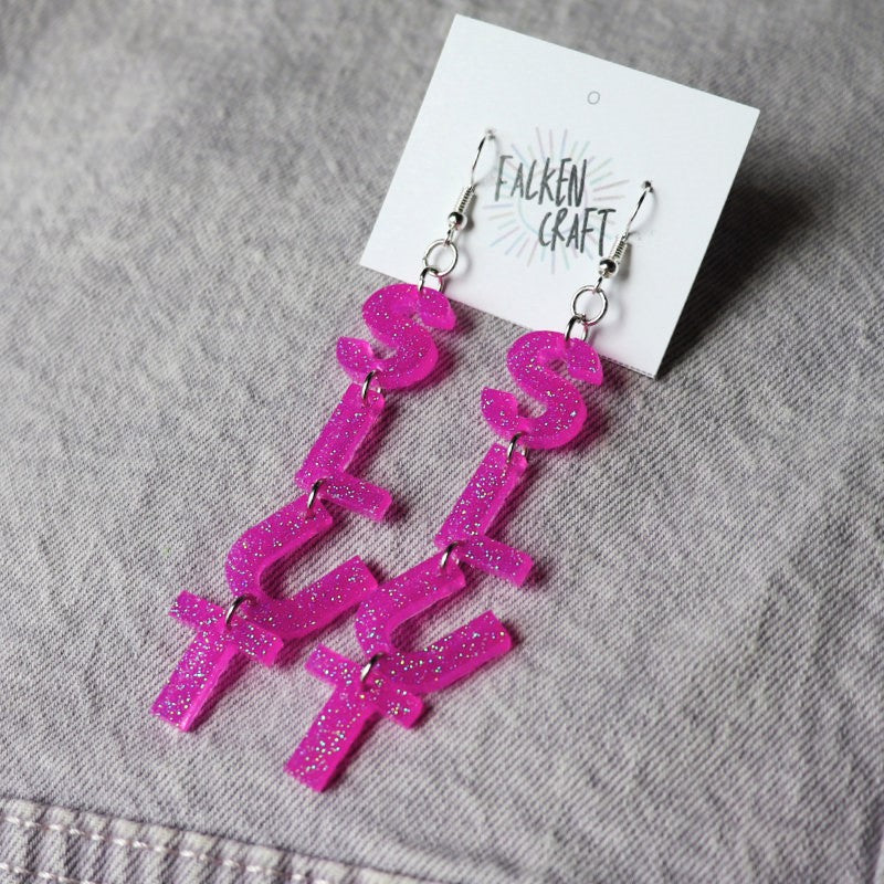 dangly earrings with letters that spell out "slut"