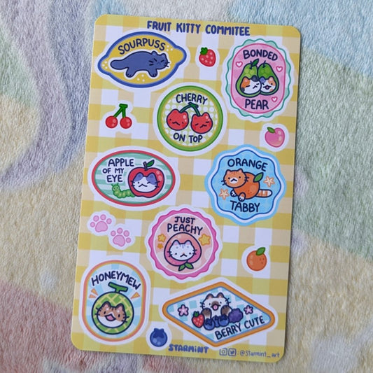 sheet of stickers showing cats, fruits, and cat/fruit combo puns