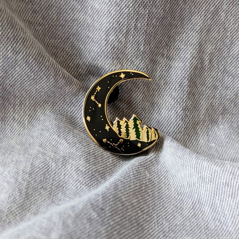 cool pin of a moon with trees on it 