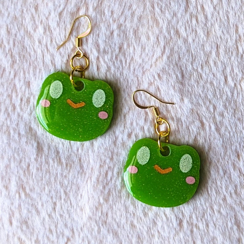 cute and glittery resin earrings of smiling frogs