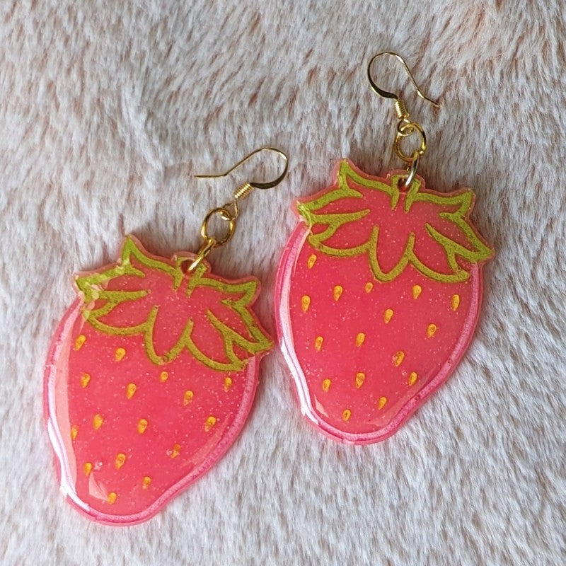 cute and glittery strawberry earrings made with resin