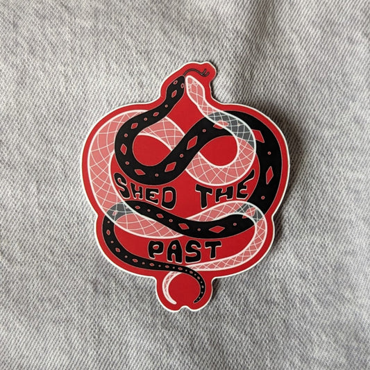 cool sticker of a snake intertwined with its shed skin and the words "shed the past"