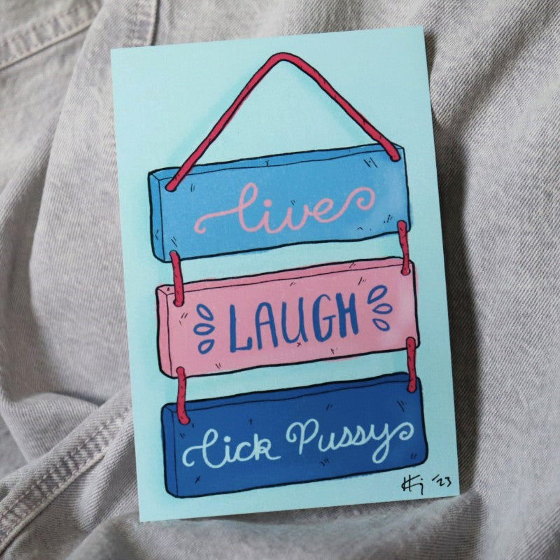 a print of a hanging sign that reads "live laugh lick pussy"