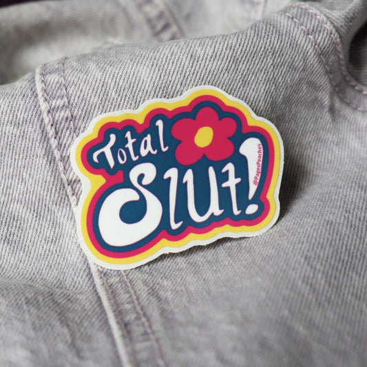 tiny sticker of a flower and the words "total slut"