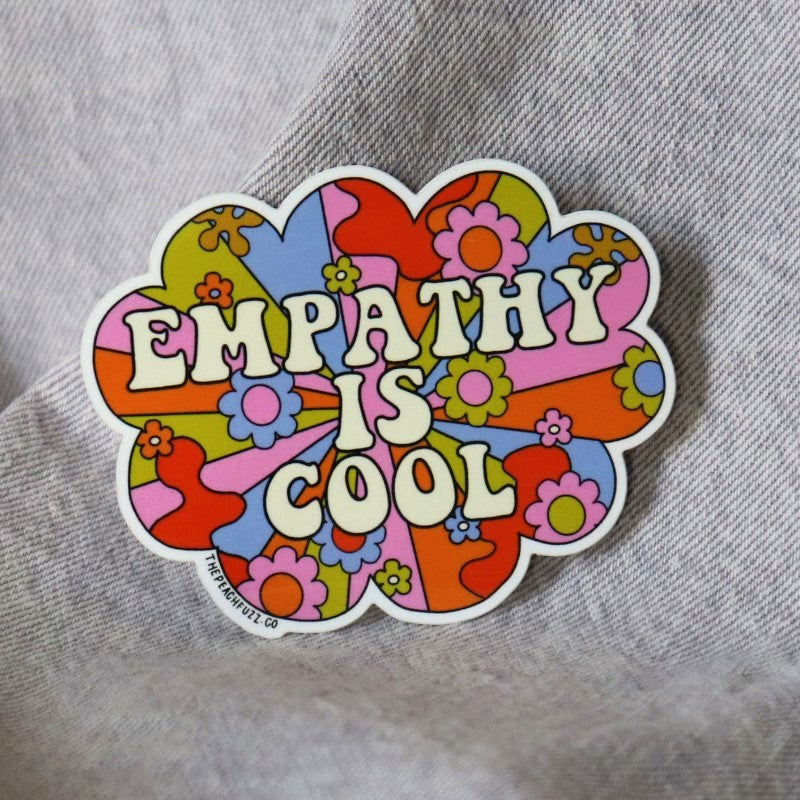 groovy sticker with a retro floral design and the words "empathy is cool"