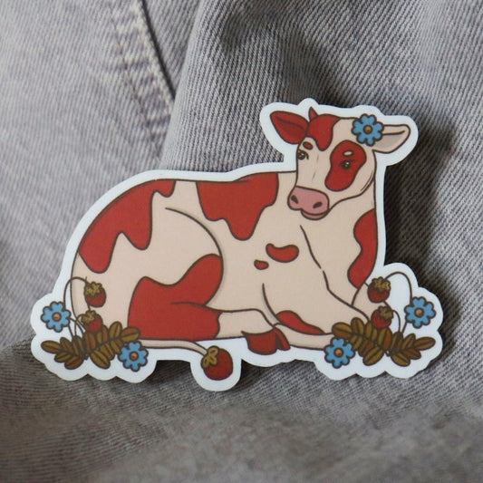 a cute sticker featuring a pink cow and flowers