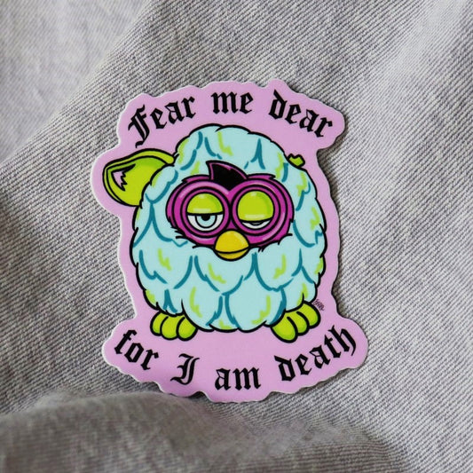 scary sticker of a retro toy and the words "fear me dear for i am death"
