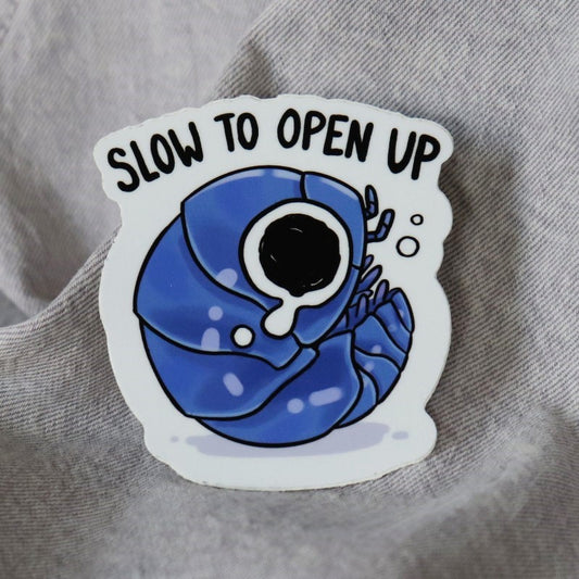 funny sticker of a crying isopod and the words "slow to open up"