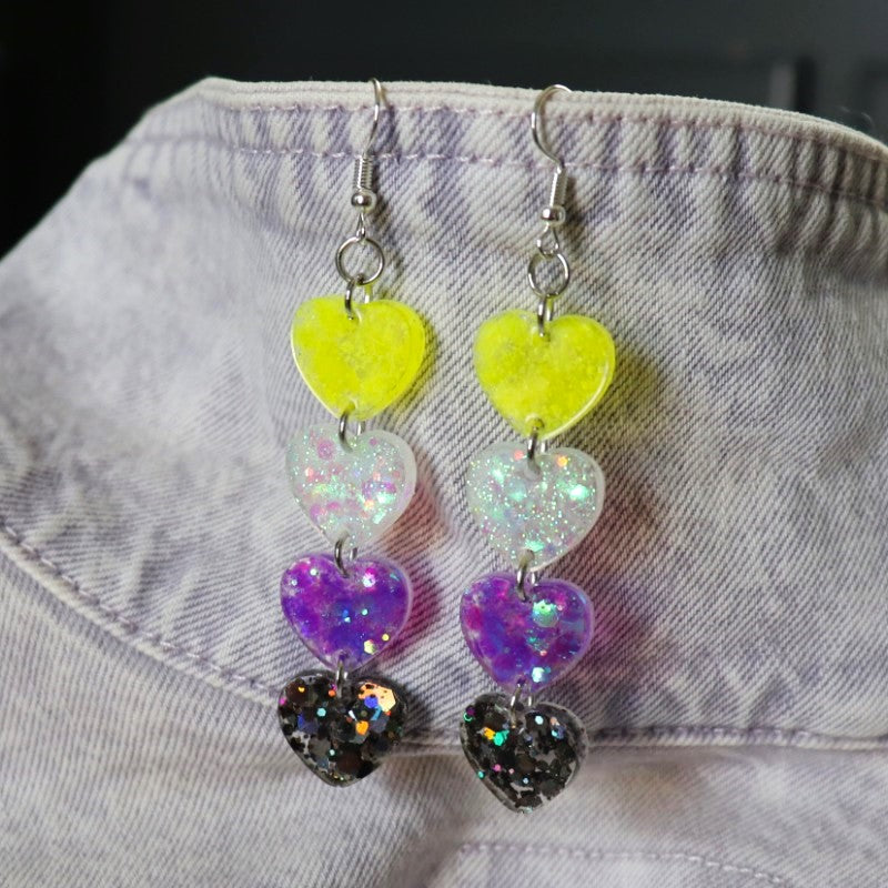 dangly earrings with hearts in the colors of the nonbinary flag